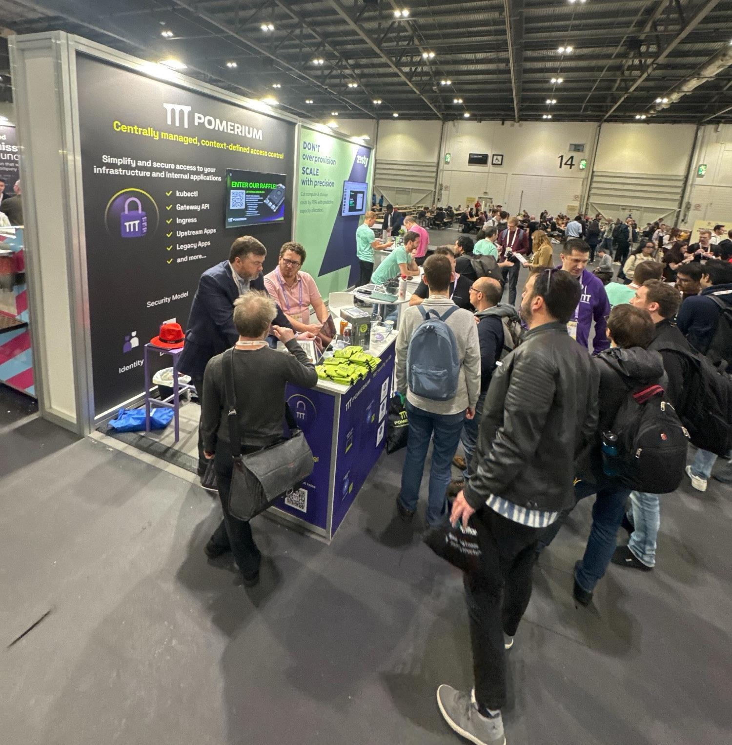 The Pomerium booth at KubeCon EU with lots of people coming by to chat